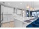 Modern kitchen features white cabinets, stainless steel appliances, and a large island at 12854 Boggy Creek Dr, Riverview, FL 33579