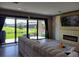 Living room with fireplace and view of the outdoor green space through the sliding glass door at 12854 Boggy Creek Dr, Riverview, FL 33579