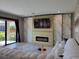 Inviting living room with a fireplace, large sliding glass doors, and a comfortable couch at 12854 Boggy Creek Dr, Riverview, FL 33579