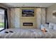 Comfortable living room featuring a stylish fireplace, a large window, and modern decor at 12854 Boggy Creek Dr, Riverview, FL 33579