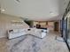 Open-concept living space with a modern sofa, area rug, and view into the kitchen at 12854 Boggy Creek Dr, Riverview, FL 33579