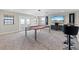 Living room featuring a pool table with a red felt, TV, and bar seating at 12854 Boggy Creek Dr, Riverview, FL 33579
