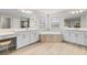 Bright bathroom featuring double vanities, a soaking tub, and a separate shower at 12854 Boggy Creek Dr, Riverview, FL 33579