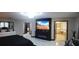 Bedroom featuring elegant decor, a fireplace, large TV, and an ensuite bathroom entrance at 12854 Boggy Creek Dr, Riverview, FL 33579