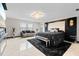Luxurious main bedroom with stylish black and white decor and a modern chandelier at 12854 Boggy Creek Dr, Riverview, FL 33579