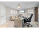 Home office with two windows, large desk, and comfortable couch at 12854 Boggy Creek Dr, Riverview, FL 33579