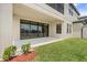 Patio with expansive windows, lake view, and manicured lawn at 12854 Boggy Creek Dr, Riverview, FL 33579