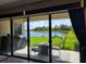 View from the patio of a tranquil lake scene, including outdoor seating and BBQ at 12854 Boggy Creek Dr, Riverview, FL 33579