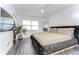 Bedroom featuring a luxurious upholstered bed, modern ceiling fan and a window with blinds at 300 Venetian Dr # 7, Clearwater, FL 33755
