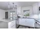 Bright kitchen featuring white cabinets, gray countertops, and modern pendant lighting at 300 Venetian Dr # 7, Clearwater, FL 33755