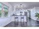 Open-concept kitchen with island seating, sleek appliances, and modern pendant lights at 300 Venetian Dr # 7, Clearwater, FL 33755