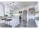 Modern kitchen with stainless steel appliances, island with seating, and stylish backsplash at 300 Venetian Dr # 7, Clearwater, FL 33755