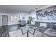 Comfortable living room adjacent to a modern kitchen, featuring a plush sofa and glass coffee table at 300 Venetian Dr # 7, Clearwater, FL 33755