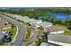 An aerial view showcasing a neighborhood with lake views and mature trees at 19891 Bridgetown Loop, Venice, FL 34293