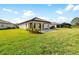 Expansive backyard with lush grass, a covered patio, offering the perfect outdoor living space at 19891 Bridgetown Loop, Venice, FL 34293