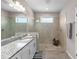 Bright bathroom featuring a glass-enclosed shower, granite countertops, and modern fixtures at 19891 Bridgetown Loop, Venice, FL 34293