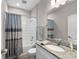 Well-lit bathroom featuring a granite vanity, a large mirror, and a shower/tub combo at 19891 Bridgetown Loop, Venice, FL 34293