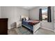 Cozy bedroom featuring neutral walls, wood-look floors, a comfortable twin bed, and a warm, inviting atmosphere at 19891 Bridgetown Loop, Venice, FL 34293