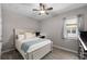 Comfortable bedroom with neutral walls, wood-look floors, a full bed, desk, and a tranquil atmosphere at 19891 Bridgetown Loop, Venice, FL 34293