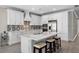 Modern kitchen features white cabinetry, quartz countertops, a tile backsplash, and stainless steel appliances at 19891 Bridgetown Loop, Venice, FL 34293