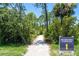 A picturesque walking trail surrounded by lush greenery leading to Heron Park at 19891 Bridgetown Loop, Venice, FL 34293