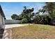 Backyard showcasing grass area, landscaping and a stone walkway and spa at 3369 Houle Ave, Sarasota, FL 34232