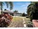 Backyard featuring a stone walkway, landscaping and views of the home at 3369 Houle Ave, Sarasota, FL 34232