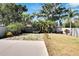 Lush backyard landscaping with mature trees, a stone walkway, privacy fence and spa at 3369 Houle Ave, Sarasota, FL 34232