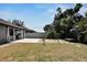 Backyard featuring landscaping, large patio, and a stone walkway at 3369 Houle Ave, Sarasota, FL 34232