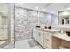Bathroom featuring double vanity, stone accent wall and a large mirror at 3369 Houle Ave, Sarasota, FL 34232