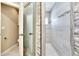 Bathroom featuring a glass shower with a stone wall and a white door at 3369 Houle Ave, Sarasota, FL 34232
