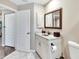 Bathroom features a white vanity, framed mirror and tiled floors, creating a functional and comfortable space at 3369 Houle Ave, Sarasota, FL 34232