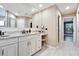 Bathroom featuring double vanity, stone accent wall and a large mirror at 3369 Houle Ave, Sarasota, FL 34232