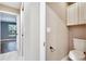 Bathroom featuring a toilet, cabinets and views of the bedroom at 3369 Houle Ave, Sarasota, FL 34232