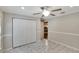 Bedroom with large closet, ceiling fan, and views into the hallway and kitchen area at 3369 Houle Ave, Sarasota, FL 34232