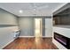 Comfortable bedroom with a fireplace, TV, ceiling fan and hardwood flooring at 3369 Houle Ave, Sarasota, FL 34232