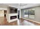Comfortable bedroom with a fireplace, TV, ceiling fan and hardwood flooring at 3369 Houle Ave, Sarasota, FL 34232