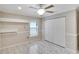 Bright bedroom featuring whitewashed wood floors, modern ceiling fan, and closet space at 3369 Houle Ave, Sarasota, FL 34232