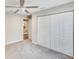 Neutral painted bedroom with carpet, ceiling fan and view into the hallway and bathroom at 3369 Houle Ave, Sarasota, FL 34232