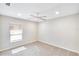 Carpeted bedroom featuring a ceiling fan, window, and neutral paint at 3369 Houle Ave, Sarasota, FL 34232
