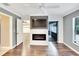 Comfortable bedroom with a fireplace, TV, ceiling fan and hardwood flooring at 3369 Houle Ave, Sarasota, FL 34232