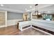 Dining area features a built-in bench, wood floors, and elegant lighting, perfect for Gathering meals at 3369 Houle Ave, Sarasota, FL 34232