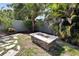 Outdoor fire pit with stone accents and backyard landscaping at 3369 Houle Ave, Sarasota, FL 34232