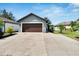 Attractive single-story home with a paved driveway, fresh landscaping, and a spacious two-car garage at 3369 Houle Ave, Sarasota, FL 34232