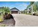 Inviting single-story home with well-manicured landscaping, a spacious driveway, and a two-car garage at 3369 Houle Ave, Sarasota, FL 34232