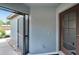 The front porch features a storm door with glass panes and a screen door, as well as an exterior window at 3369 Houle Ave, Sarasota, FL 34232