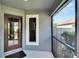 The screened front porch features a storm door and window, offering a relaxing outdoor space with a neighborhood view at 3369 Houle Ave, Sarasota, FL 34232