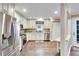Beautiful white kitchen featuring stainless steel appliances, granite countertops, and wood floors at 3369 Houle Ave, Sarasota, FL 34232
