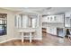 Bright kitchen featuring white cabinets, granite countertops, stainless steel appliances, and hardwood floors at 3369 Houle Ave, Sarasota, FL 34232