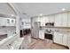 Spacious kitchen with stainless steel appliances, white cabinetry, granite countertops, and hardwood floors at 3369 Houle Ave, Sarasota, FL 34232